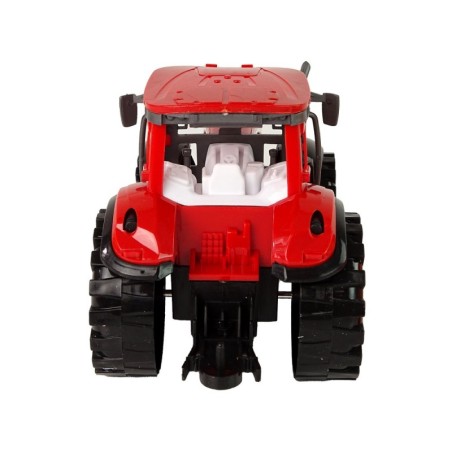 Punane oranži kultivaatori ajamiga traktor