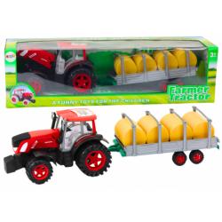 Suur põllutraktor haagise ja heinapallide...