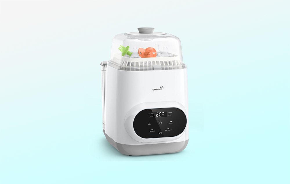 Bottle washer on a light background, with toys and pacifiers inside and an active display