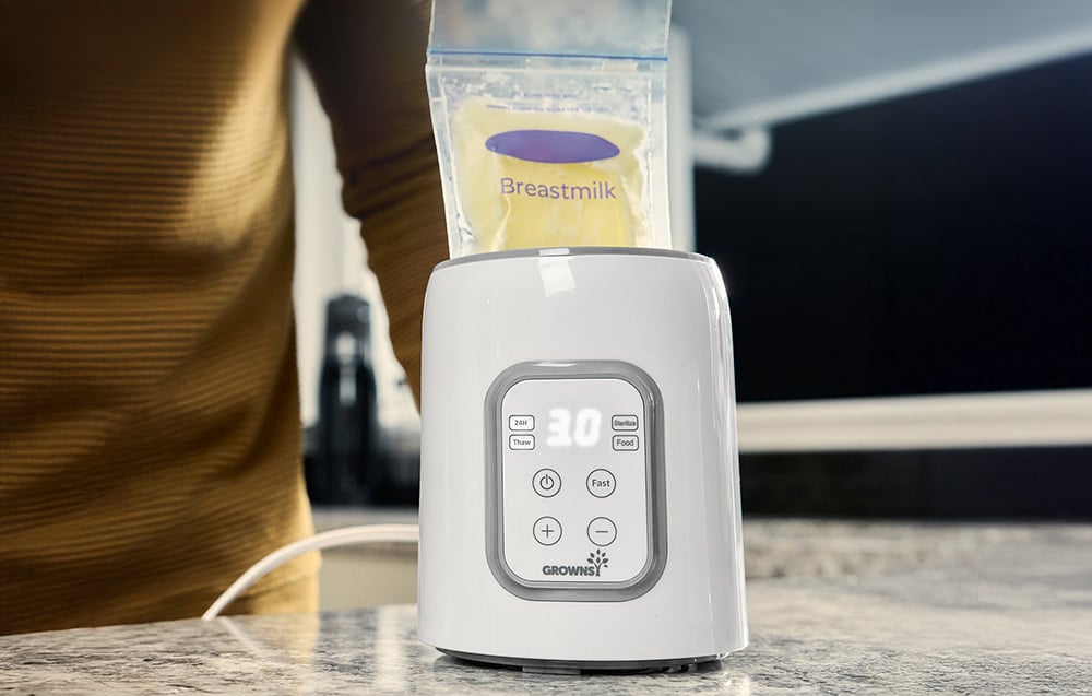 Close-up of a bottle warmer with a bag of milk labeled