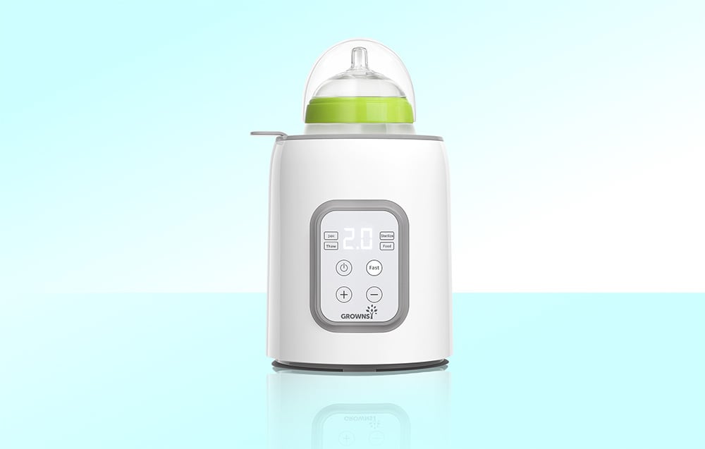 Bottle warmer with baby bottle inserted, on a light background